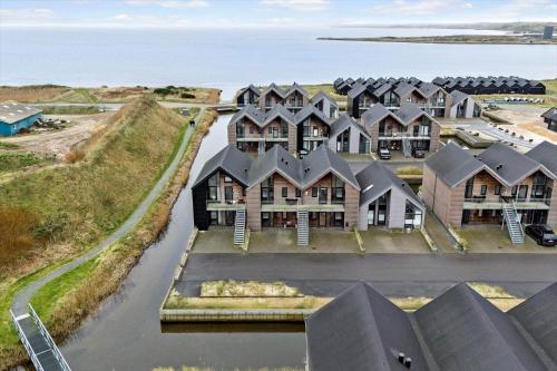 an aerial view of a house with the ocean in the background at 9929-Hvide-Sande-Langsand-194-stuen in Hvide Sande
