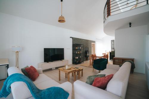 a living room with a white couch and a table at Dolce Luxury Villa in Nižepole