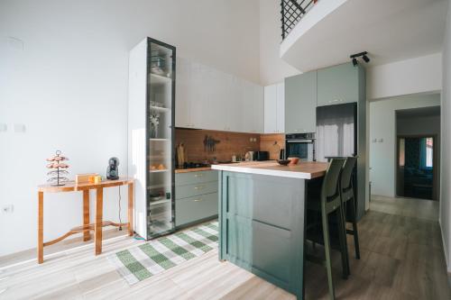 a kitchen with white cabinets and a wooden table at Dolce Luxury Villa in Nižepole