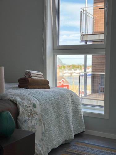 a bedroom with a bed and a large window at Mountain and Sea View Svolvær in Svolvær