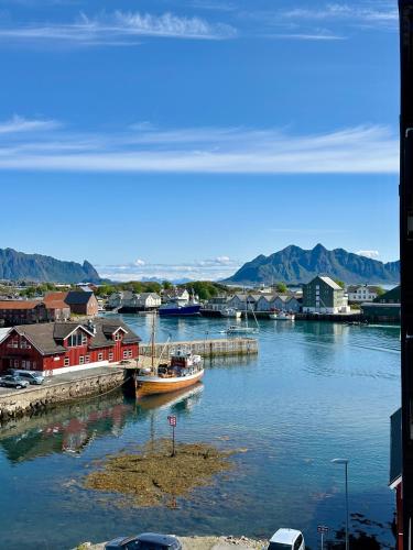 a boat docked at a dock in a body of water at Mountain and Sea View Svolvær in Svolvær