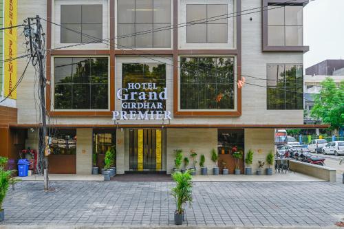 a building with a sign for a hotel grand german pharmacy at Hotel Grand Girdhar Premier in Indore
