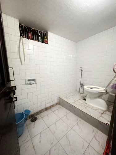 a dirty bathroom with a toilet in a room at Babu vishwanath singh Paying Guesthouse in Varanasi