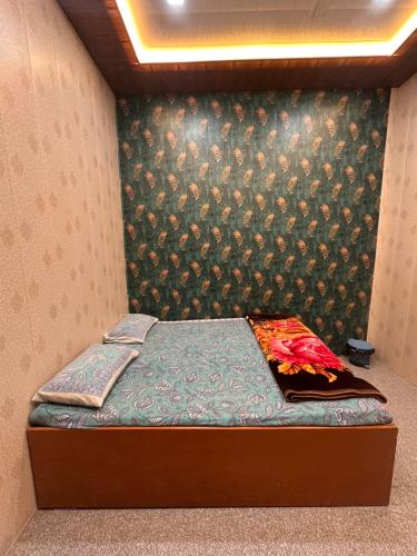 a small bed in a room with a wall at Babu vishwanath singh Paying Guesthouse in Varanasi