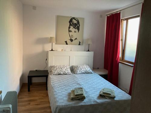 a bedroom with a bed with two shoes on it at Garden apartment in Karlovo