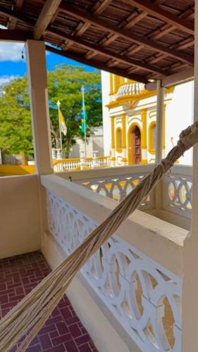 a hammock on a balcony of a building at Pousada Casa Grande in São Lourenço