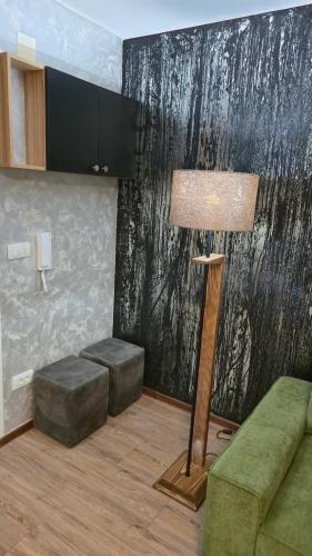 a living room with a lamp and a couch at Apartman Tanja in Nova Varoš