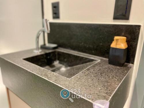 a kitchen counter with a sink and a soap bottle at Get Sense By 123Quarto Hospedagem in Tambaú