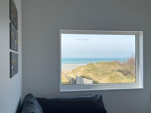 a window in a room with a view of the ocean at Beach House in Port-Bail-sur-Mer