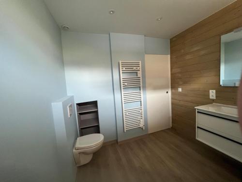 a bathroom with a toilet and a sink at Beach House in Port-Bail-sur-Mer
