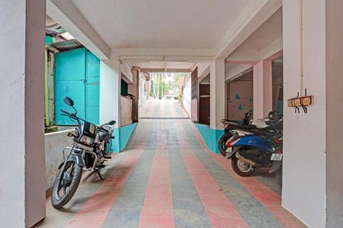 two motorcycles parked in the hallway of a building at SPOT ON The New View Regency in Trivandrum