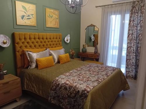 a bedroom with a large bed and a mirror at Χρυσηίδα - Chrysiida Luxury Apartment in Nafplio