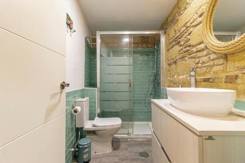 a bathroom with a sink and a toilet and a shower at Exclusive Boutique in Jerez de la Frontera