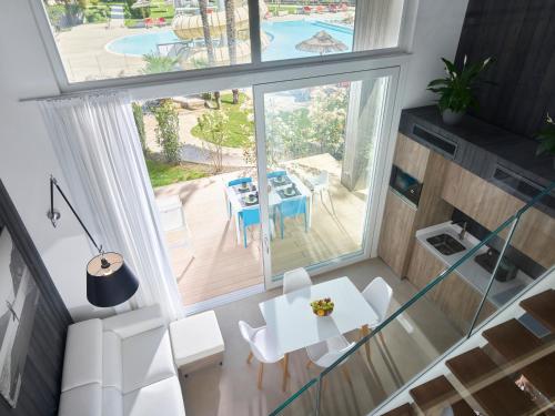 an overhead view of a living room with a table and chairs at Garda Sporting Club Hotel in Riva del Garda