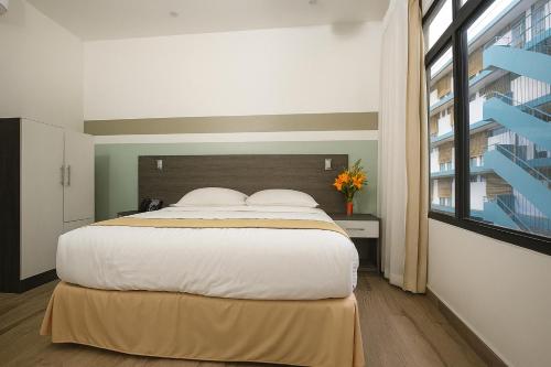 Un ou plusieurs lits dans un hébergement de l'établissement Hotel Cultura Plaza