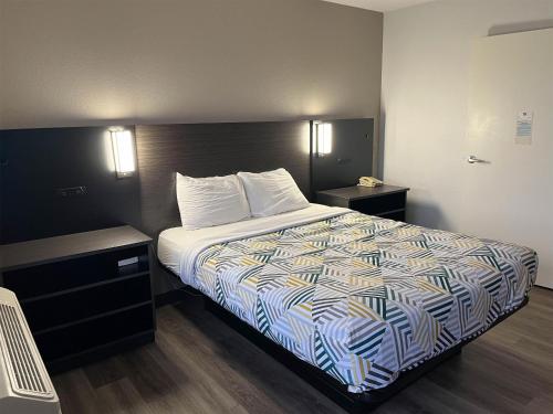 a hotel room with a bed and two night stands at Motel 6-Elkton, MD in Elkton