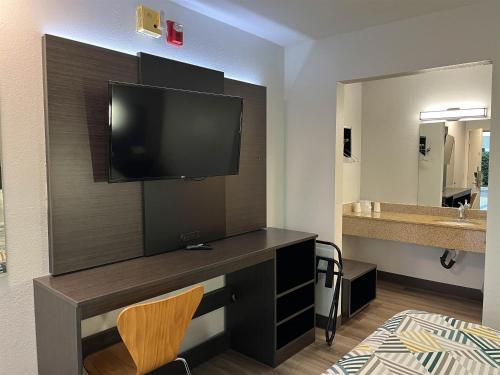 a room with a desk with a television and a bathroom at Motel 6-Elkton, MD in Elkton