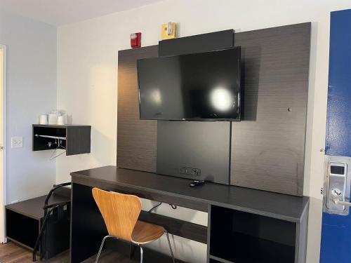 a room with a desk with a tv on a wall at Motel 6-Elkton, MD in Elkton