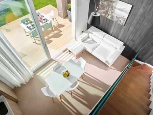an overhead view of a living room with a table and chairs at Garda Sporting Club Hotel in Riva del Garda