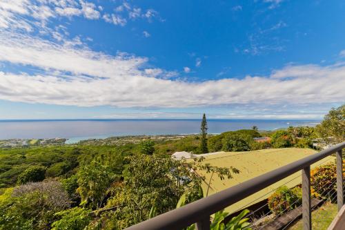 a view of the ocean from the balcony of a house at Aloha Casa Miramar by SkyRun Kona Coast in Kailua-Kona