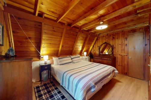a bedroom with a bed in a wooden cabin at A-Frame on East Bay in Williamsburg