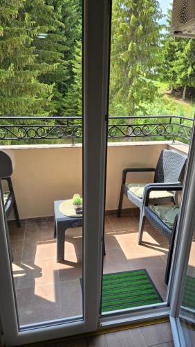 a screened in porch with a view of a patio at Apartman Tanja in Nova Varoš