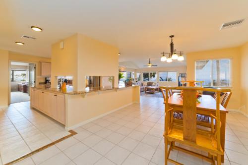 a kitchen and living room with a table and chairs at Kona Vistas by SkyRun Kona Coast in Kailua-Kona