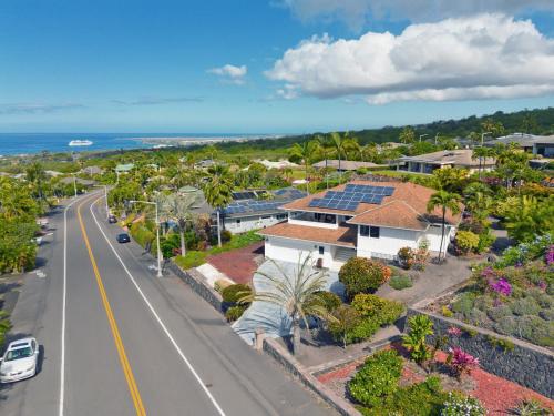 an aerial view of a road and houses with solar panels at Kona Vistas by SkyRun Kona Coast in Kailua-Kona