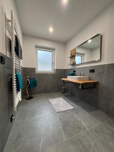 a bathroom with a sink and a mirror at Haischberger Apartments in Obertraun