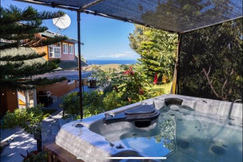 a jacuzzi tub with a view of the ocean at Lua Hoana Place by SkyRun Kona Coast in Waikoloa Village