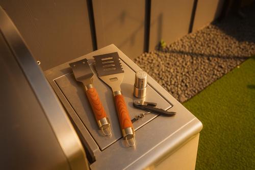 a tool box with two knives on top of it at Fun-Filled Backyard Firepit Grill Games Good Vibes in Houston