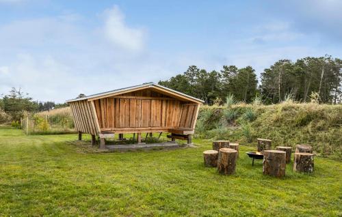 a wooden building in the middle of a field at Amazing Home In Sæby With Sauna in Sæby