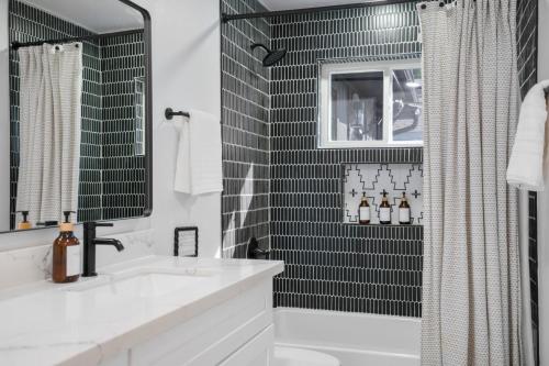 a bathroom with a white sink and a shower at Fun-Filled Backyard Firepit Grill Games Good Vibes in Houston