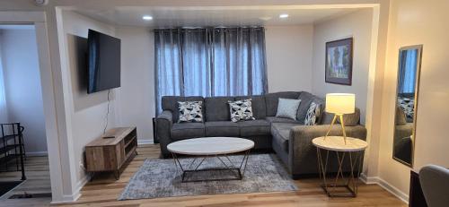 a living room with a couch and a table at Kenmore Avenue Niagara Buffalo New York 3-Bedroom entire home in Kenmore