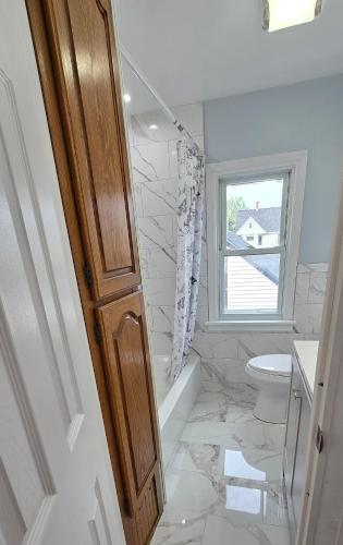 a bathroom with a toilet and a sink at Kenmore Avenue Niagara Buffalo New York 3-Bedroom entire home in Kenmore