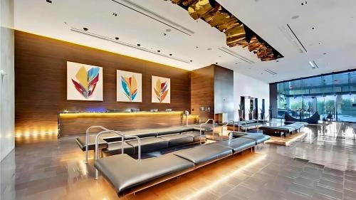 a waiting room with benches and paintings on the wall at Vista Balcony Collection - StripSuite Palms Place Hotel, Resort & Casino in Las Vegas
