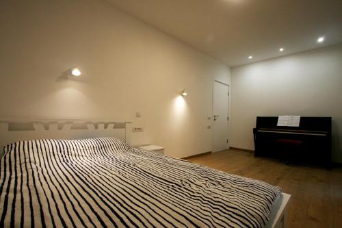 a bedroom with a bed and a dresser in it at Ada Lake new apartment in Belgrade