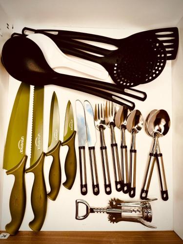 a bunch of utensils are hanging on a wall at Beautiful loft with elevator for nomad envigado in Envigado