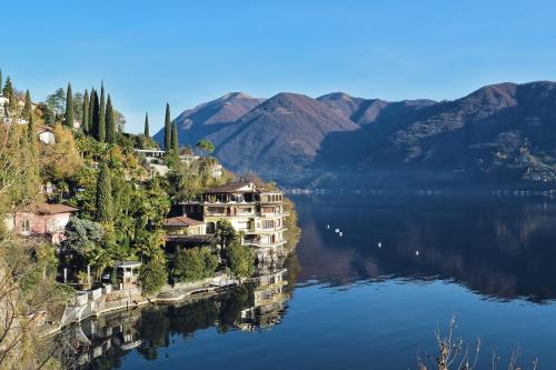 an island in the middle of a lake with mountains at Balcone Di Alex & Thomas - Happy Rentals in Val Rezzo