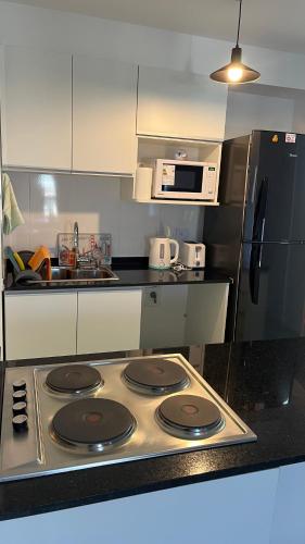 a kitchen with a stove top oven and a refrigerator at luxury Brickell Towers in Tigre