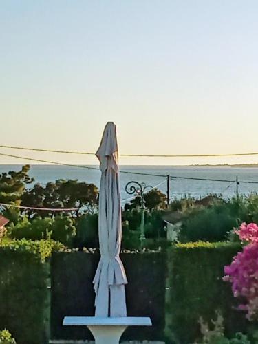 a blue umbrella sitting on a table in a garden at Studios Angeliki in Lassi