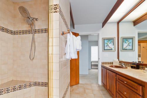 a bathroom with a shower and a sink at Aloha Casa Miramar by SkyRun Kona Coast in Kailua-Kona