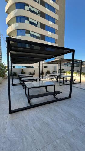 a group of benches sitting in front of a building at luxury Brickell Towers in Tigre