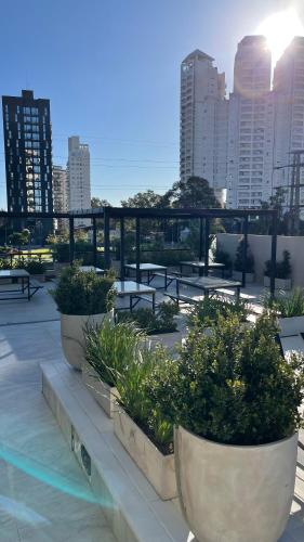 a group of benches with plants in them on a building at luxury Brickell Towers in Tigre