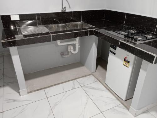 a kitchen with a sink and a stove at Hopesy's in Port Vila