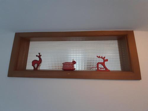 a shelf with three glass animals on it at DolomitiCasa in Venas