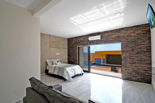 a bedroom with a bed and a brick wall at STELLA MARIS Boutique Hotel in El Sargento