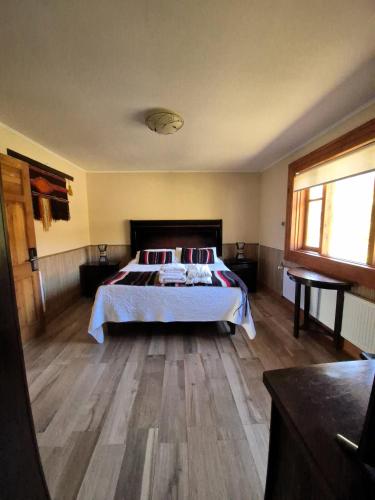a bedroom with a bed and a wooden floor at Hotel Boutique Refugio El Molle in El Molle