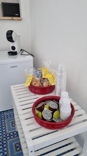 two baskets of food sitting on a white shelf at Brezza di Terra in Santa Marina Salina