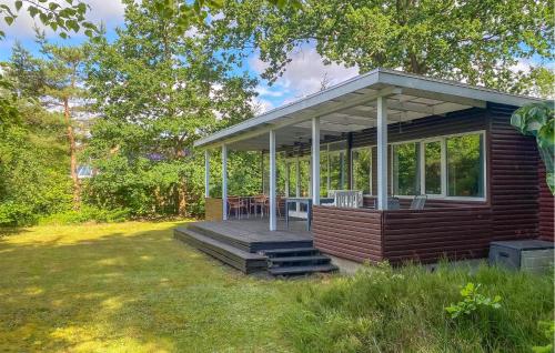 a house with a deck with a roof at Lovely Home In Egå With Wifi in Egå